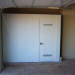 White FamilySAFE storm shelter in the corner of a garage