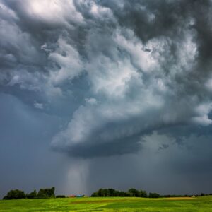 Thunderstorm over a green field