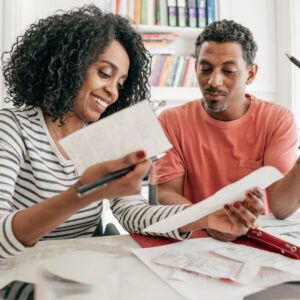 Two people looking through finance documents