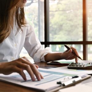 Person working with documents and a calculator