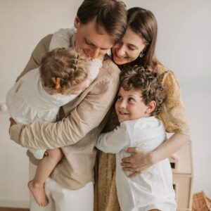 Family of four hugging