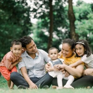 A family siting outside, while they get a safe house installed 