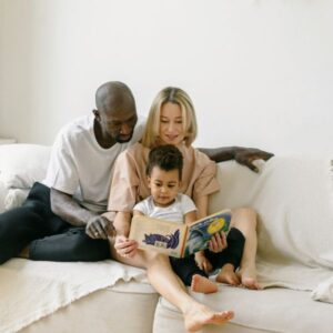 Mom and dad reading their son a book in their safe house