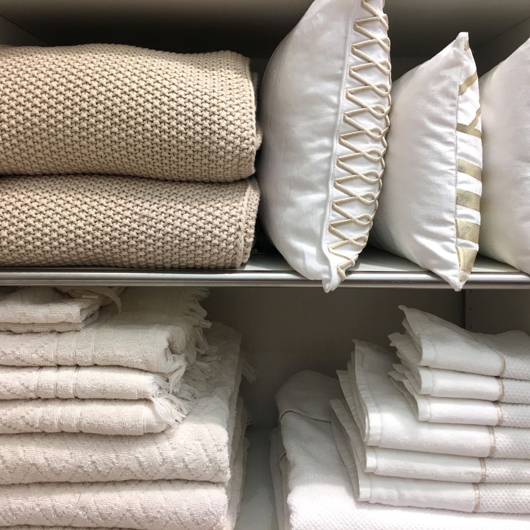 stacks of pillows, blankets, and sheets