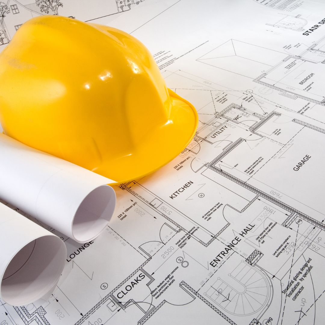 yellow construction hat on blueprint 