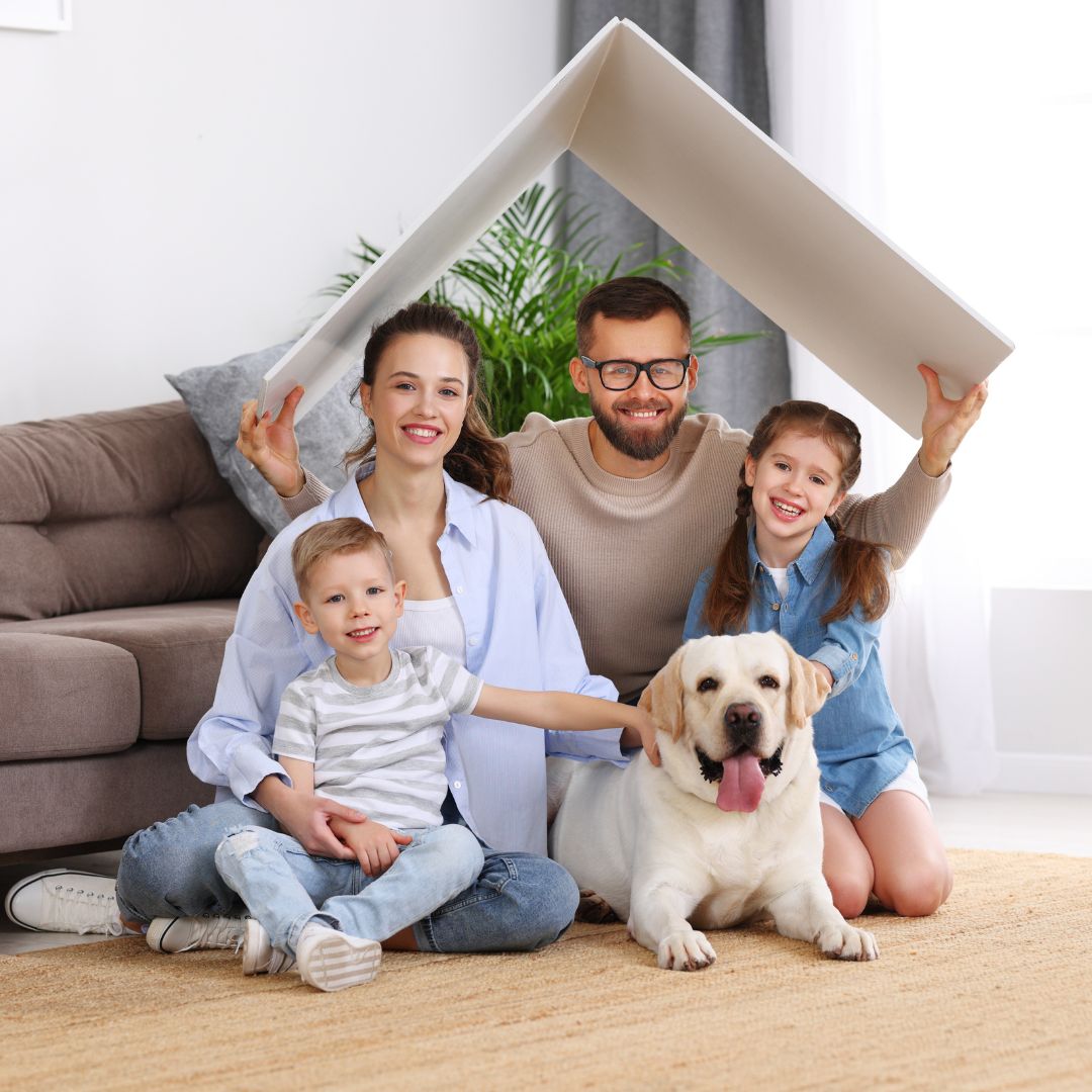 family and dog under paper roof 