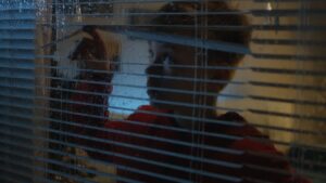 child peaking through blinds