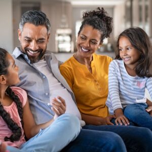 happy family sitting together on couch