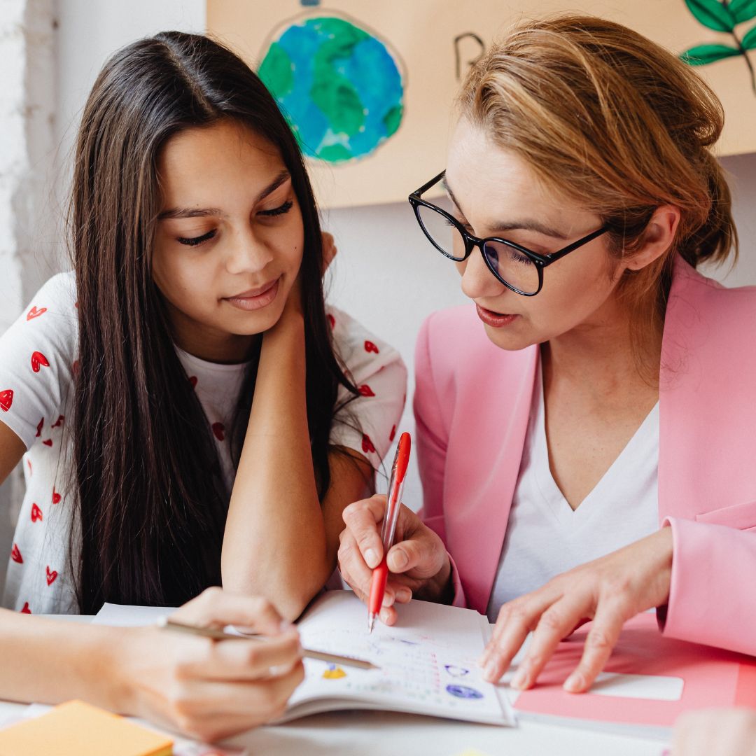 A woman teaching a girl