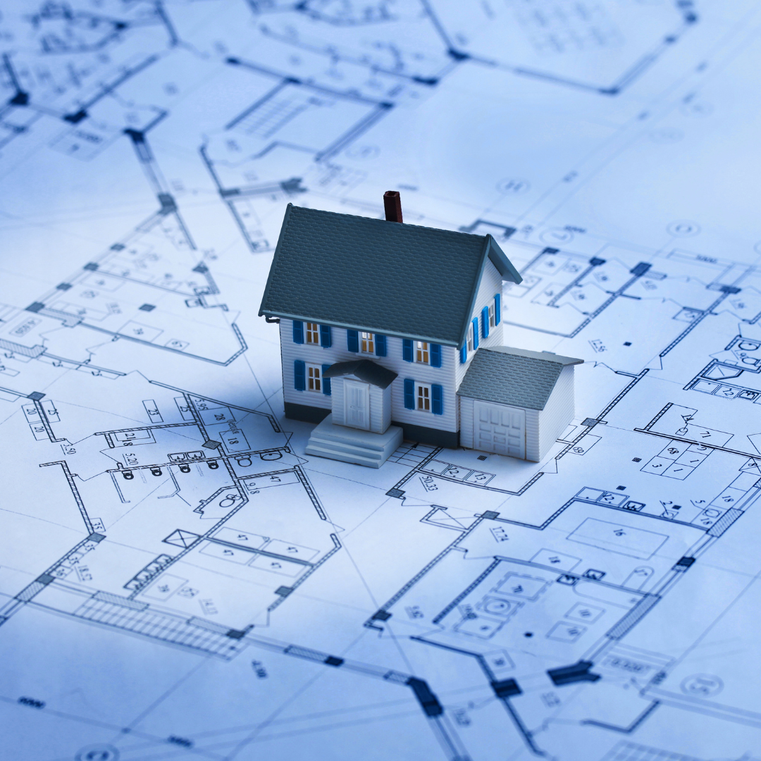Toy house on a blueprint. 
