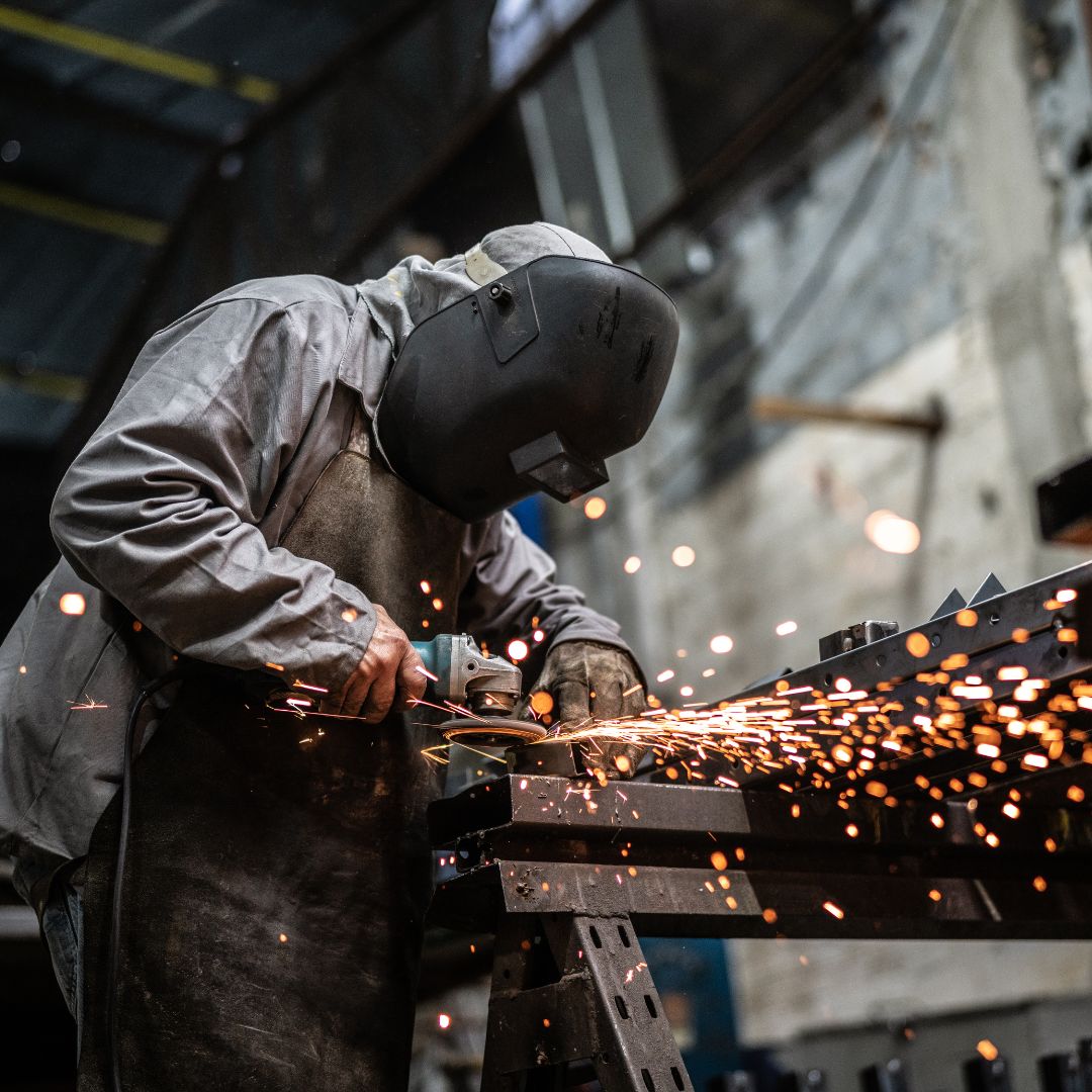 a professional in safety gear using a saw