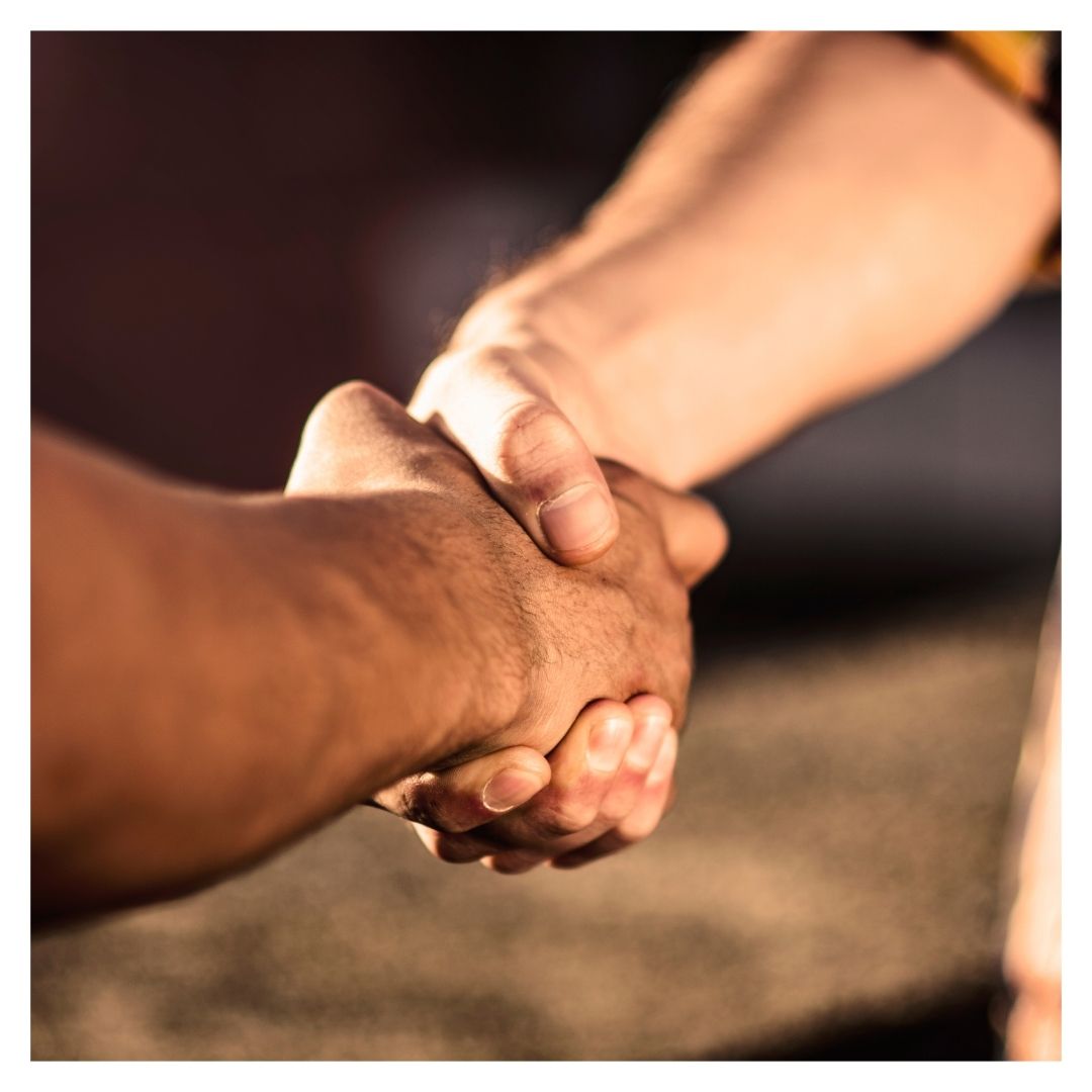 Two people shake hands