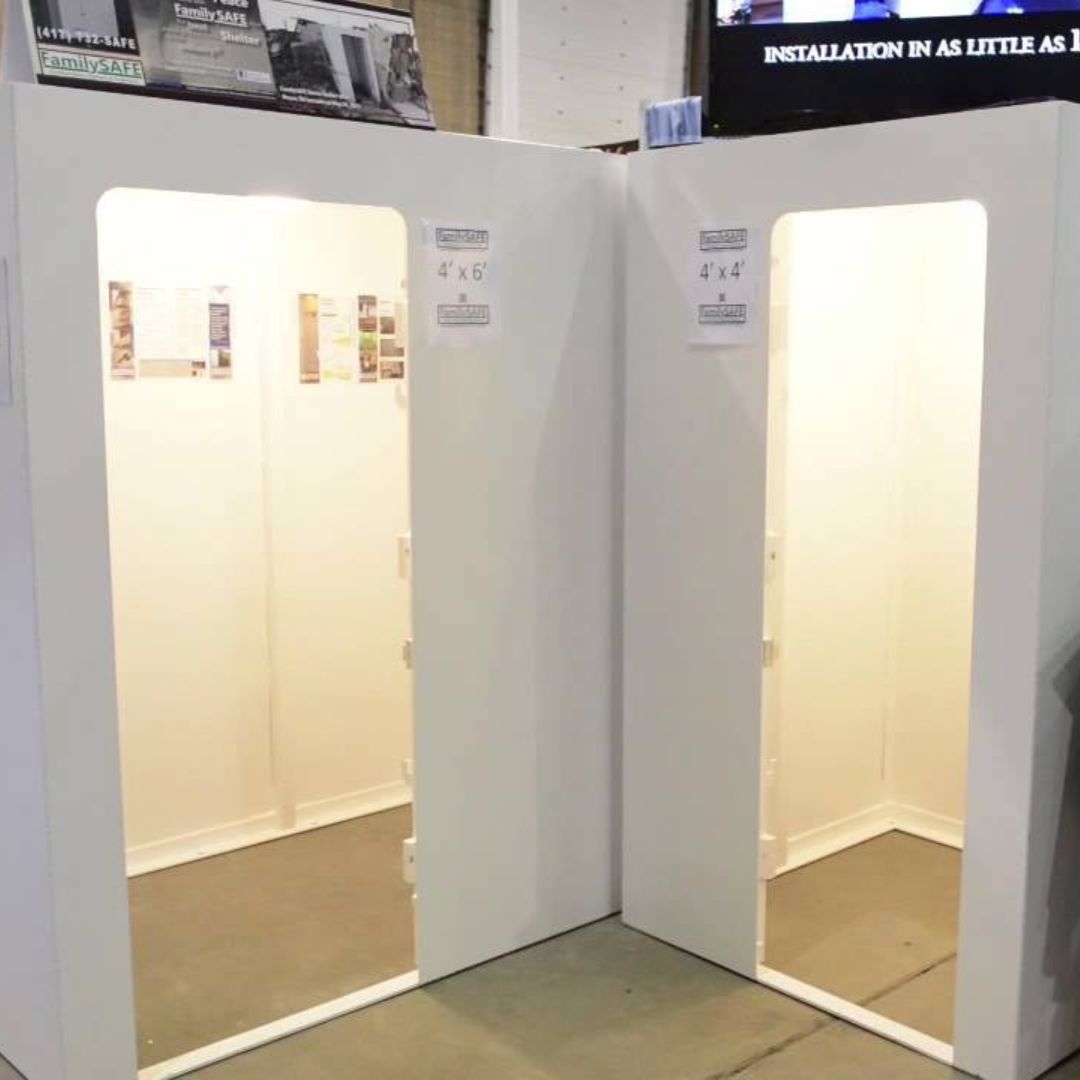 Two white storm shelters displayed side by side