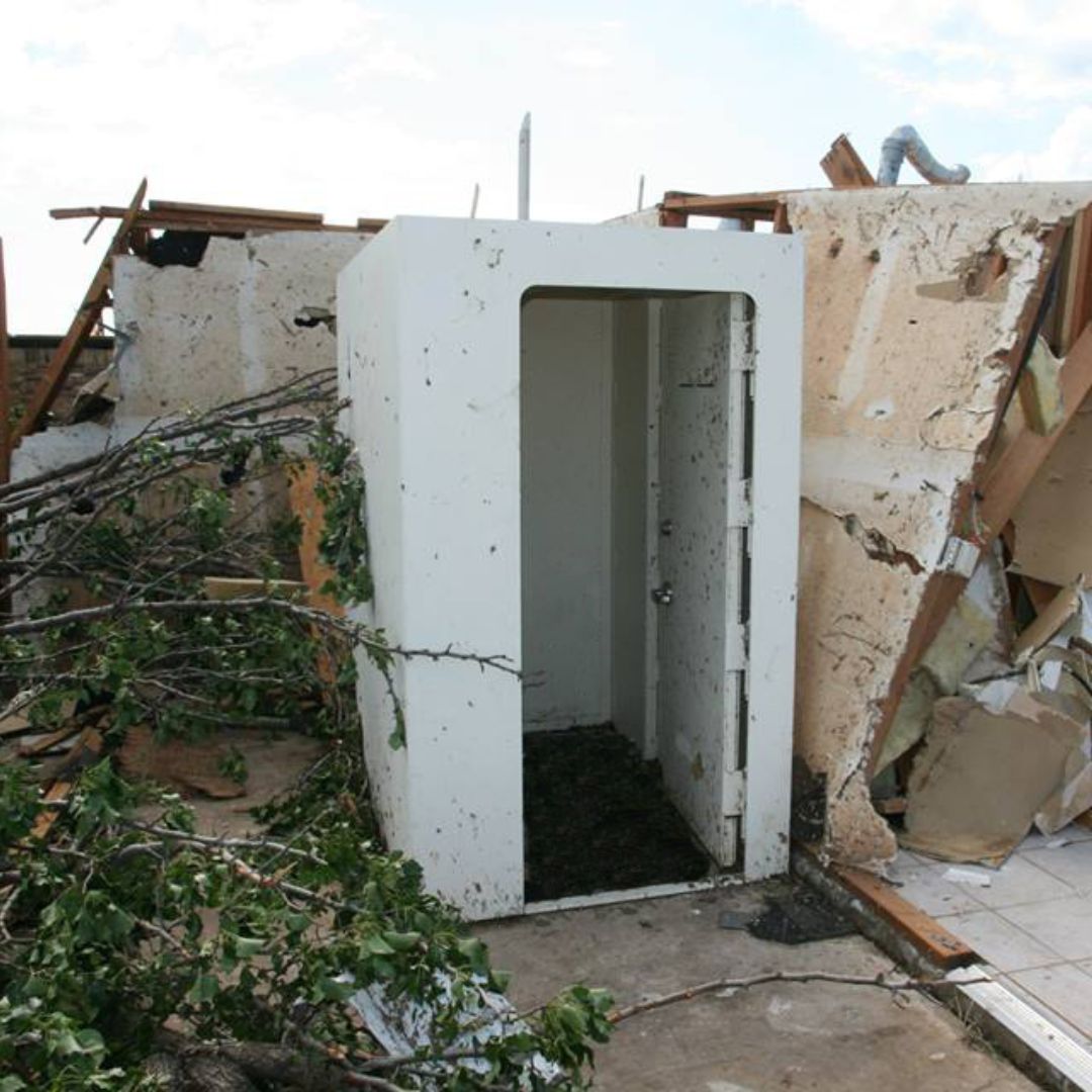 Tornado shelter intact among house debris and destruction