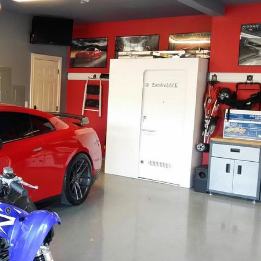 Garage with cars, motorcycle, and white safe room