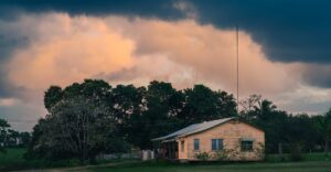 Ranch house under storm clouds