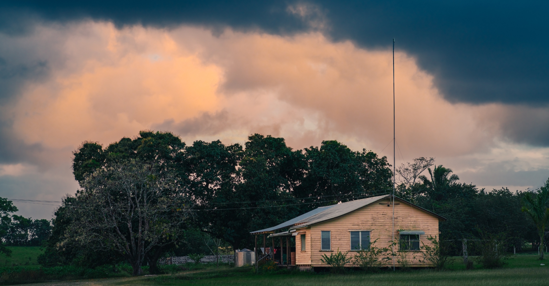 Ranch house under storm clouds