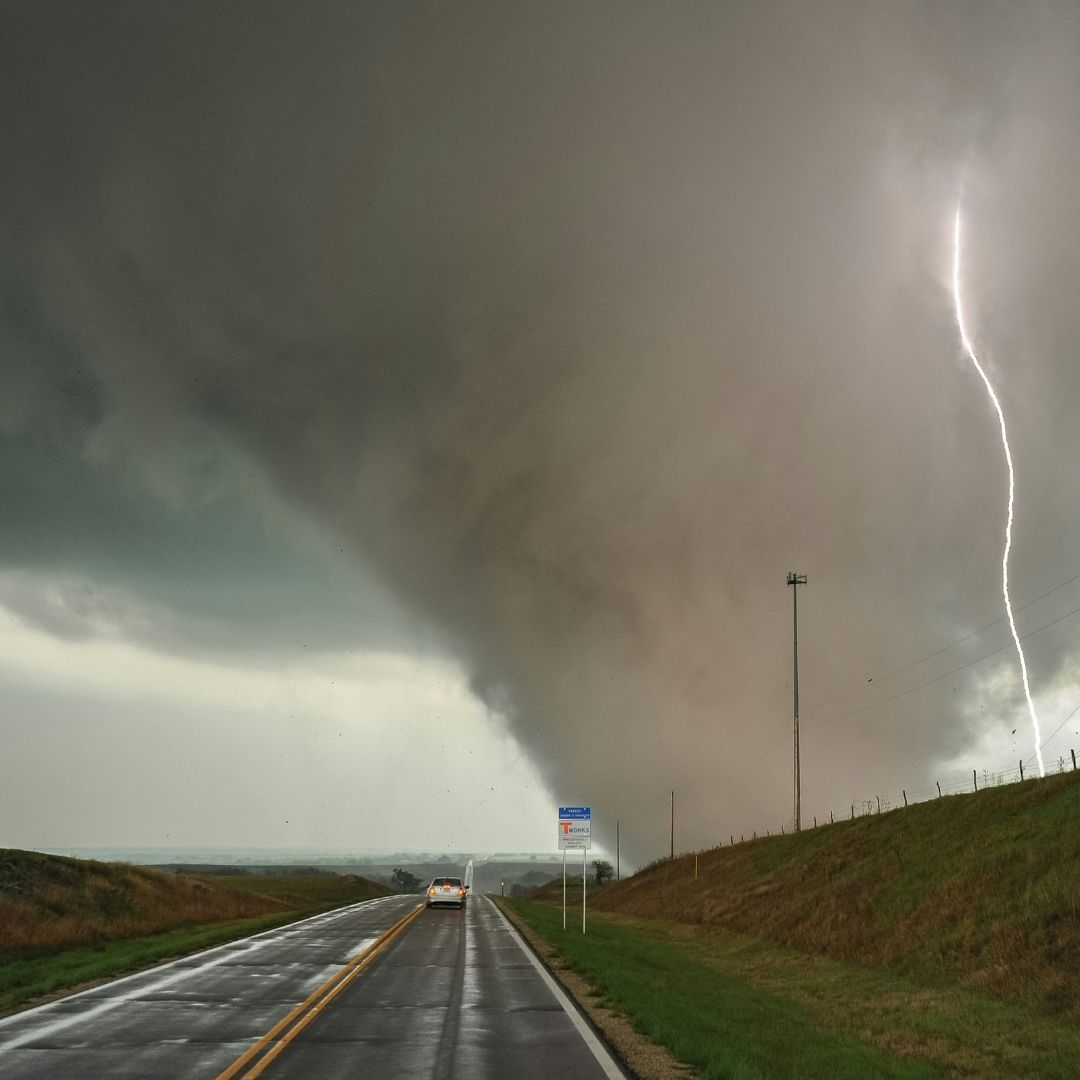 tornado and lightning strike on the side of a highway