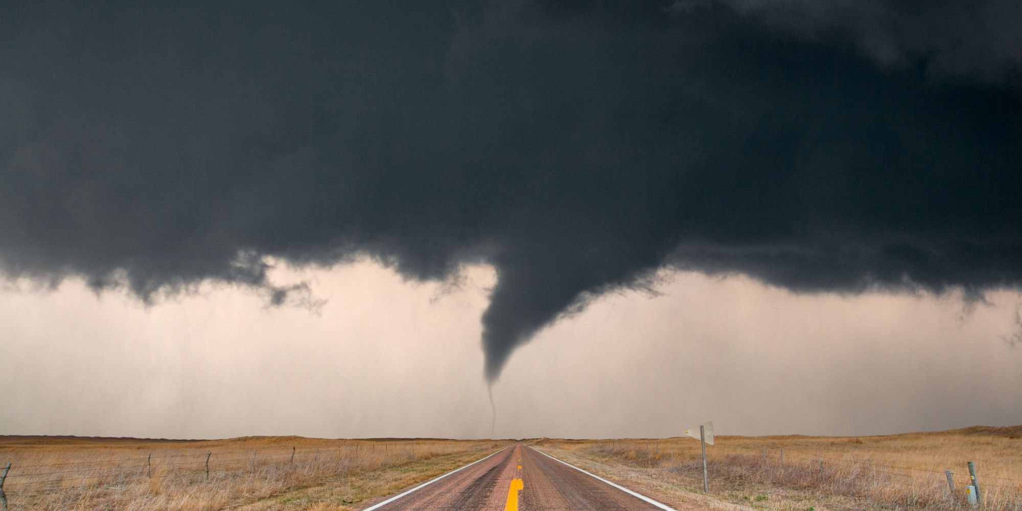 tornado hovering over highway