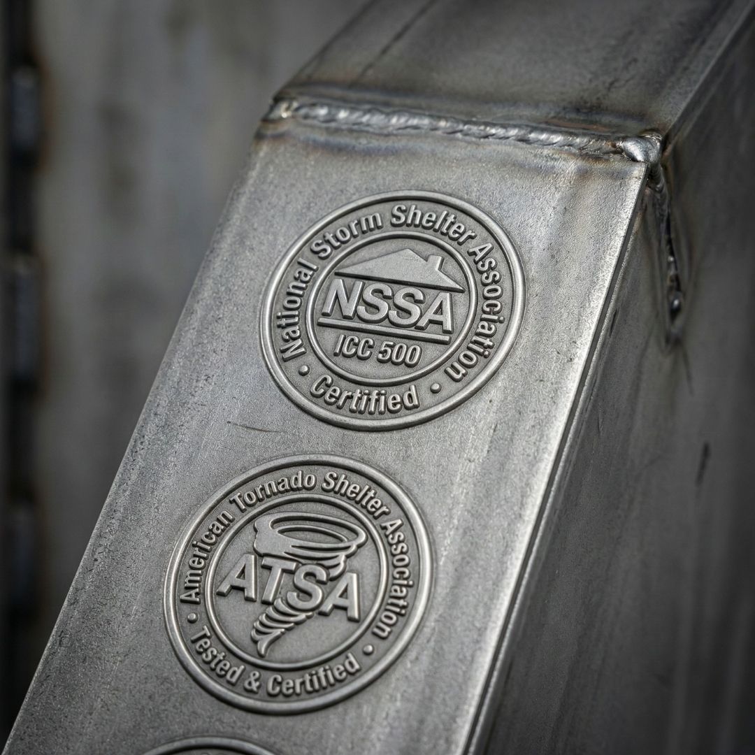 Close-up of safety certification seals on a FamilySAFE steel storm shelter.